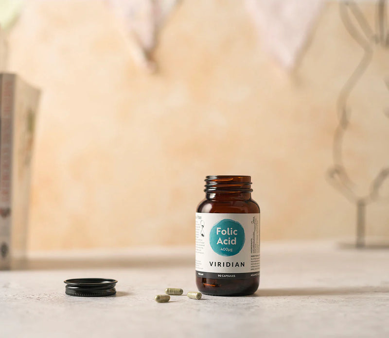 Bottle of Viridian Folic Acid on a light surface with a blurred background