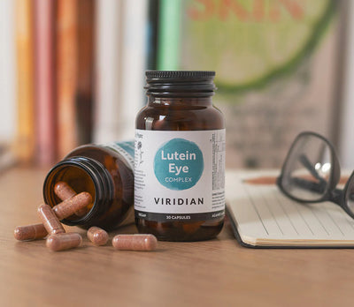 Bottle of Viridian Lutein Eye Complex with capsules on a desk