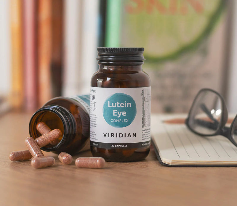Bottle of Viridian Lutein Eye Complex with capsules on a desk