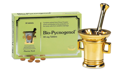 Bio-Pycnogenol packaging with tablets and a gold mortar and pestle on a white background