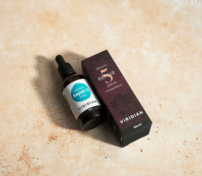 Viridian Organic Repair Serum bottle and packaging on a beige surface