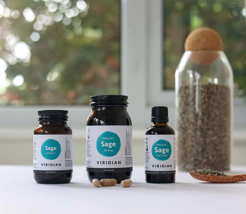 Three bottles of Viridian Organic Sage with a jar of seeds on a light surface.