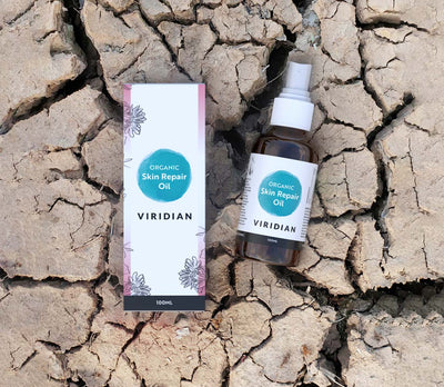 Viridian Organic Skin Repair Oil bottle and packaging on cracked earth